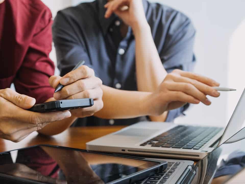 people around a laptop