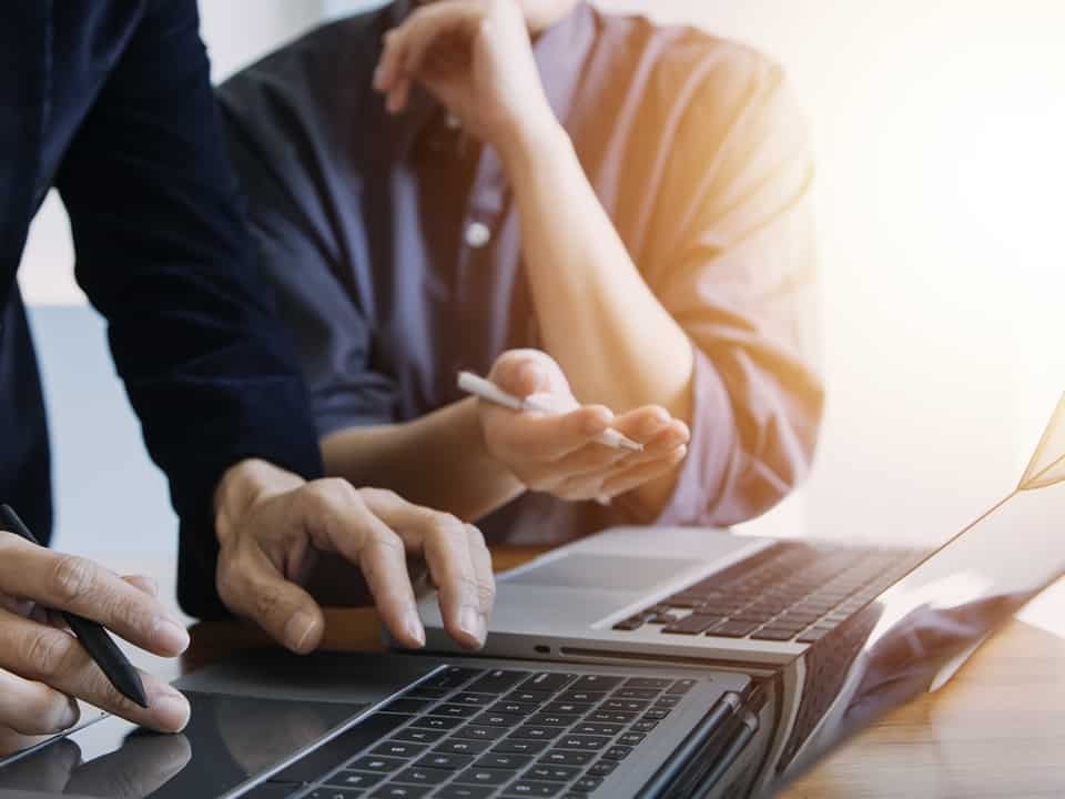 consultants around a computer